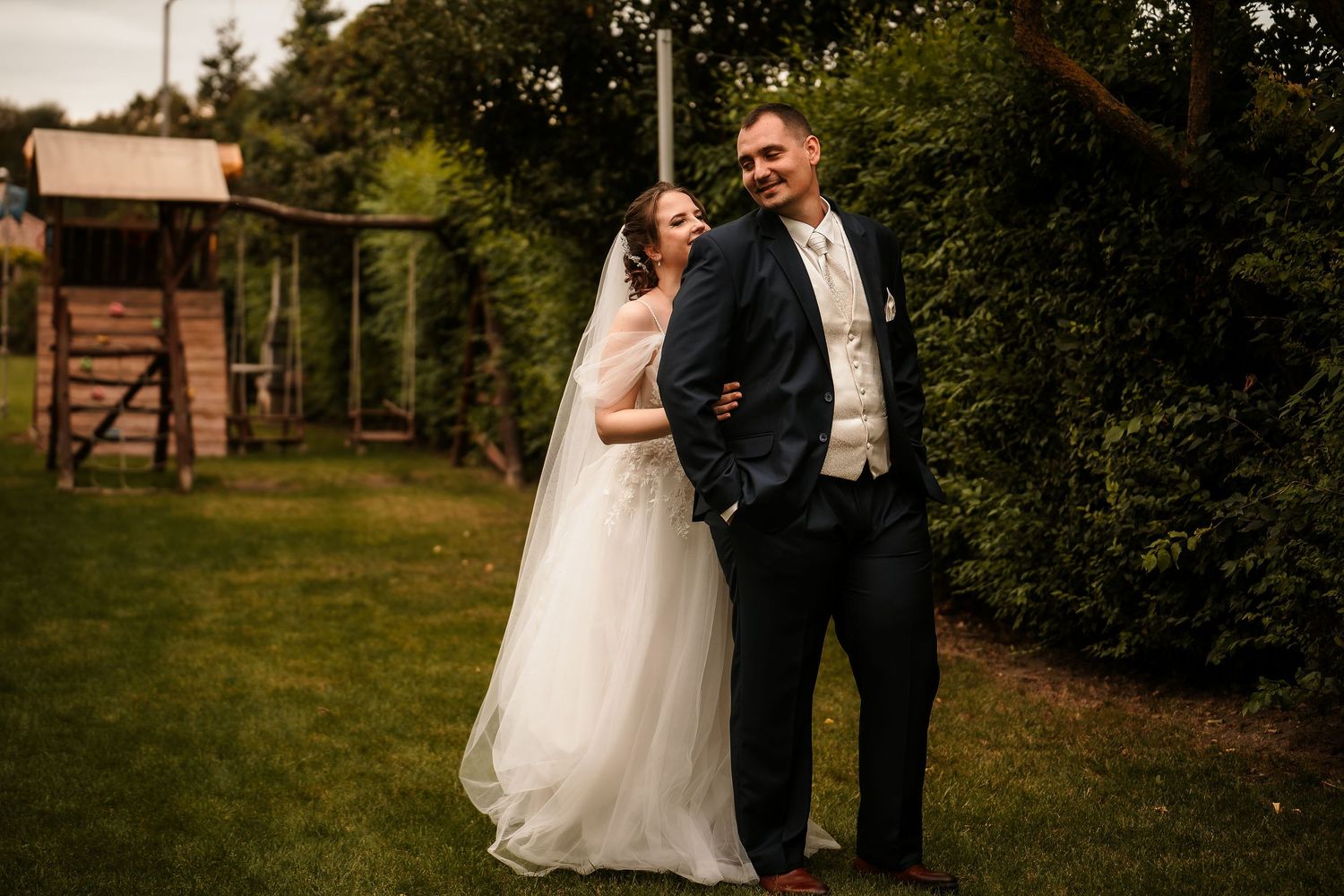 Wedding ceremony setting against rustic farm backdrop.