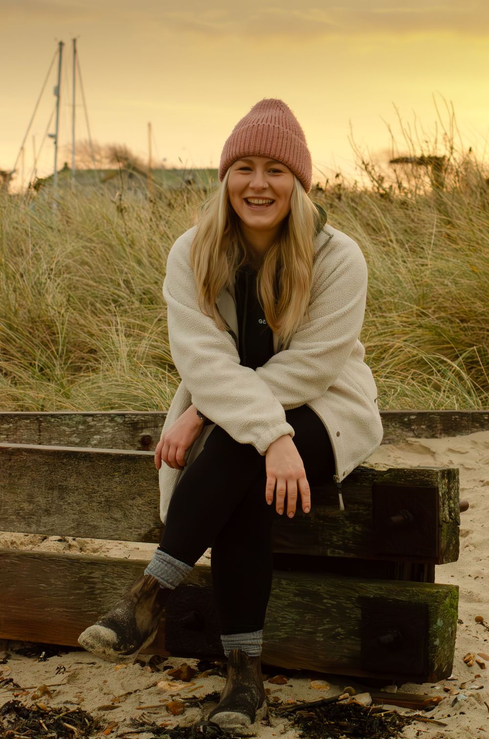 young woman smiling at sunrise golden hour