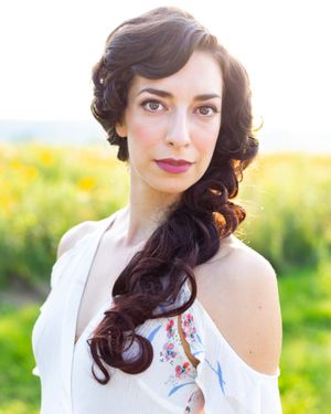 Portrait photography in a sunny field with soft natural lighting and warm golden tones.