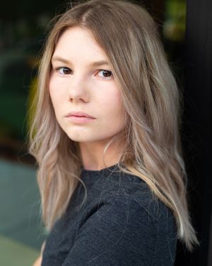 Portrait series showing ash blonde hair and natural makeup against a dark background.