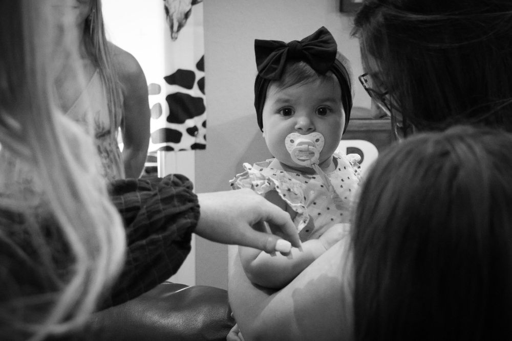 Black and white candid shots show intimate moments during a gathering.