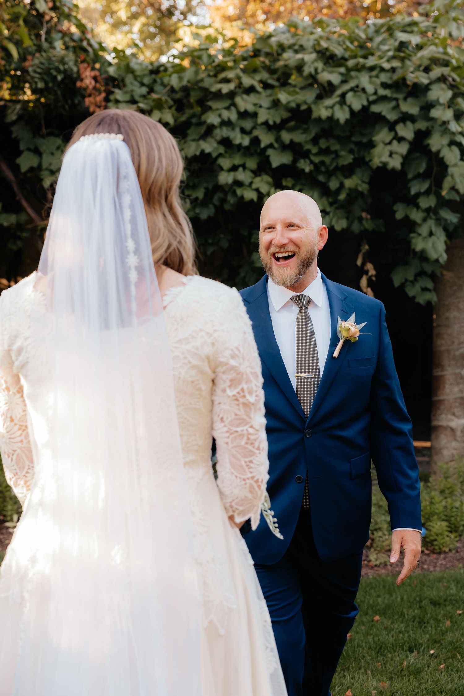 Groom seeing bride for the first time in her wedding dress