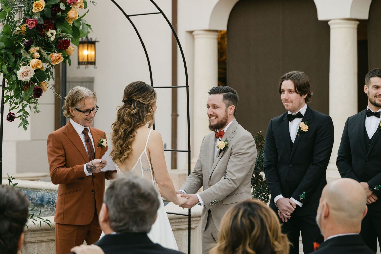 Photo of bride and groom getting married in a victorian courtyard captured by wedding photographers in Bradenton