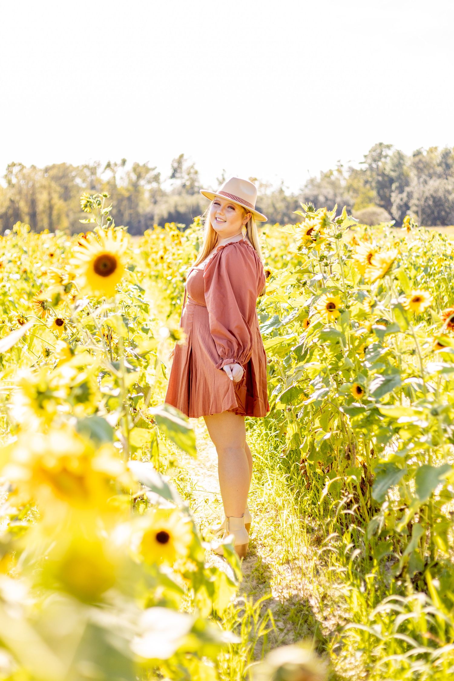 Senior girl in sunflower field