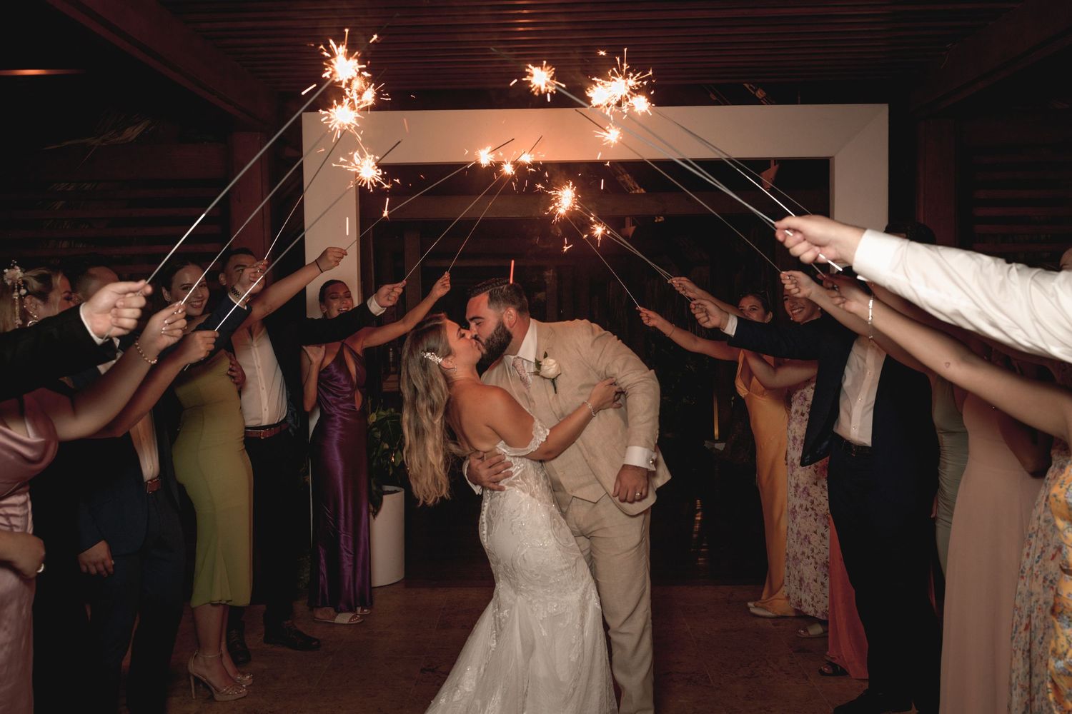 Wedding celebration with sparklers creating a magical nighttime atmosphere.