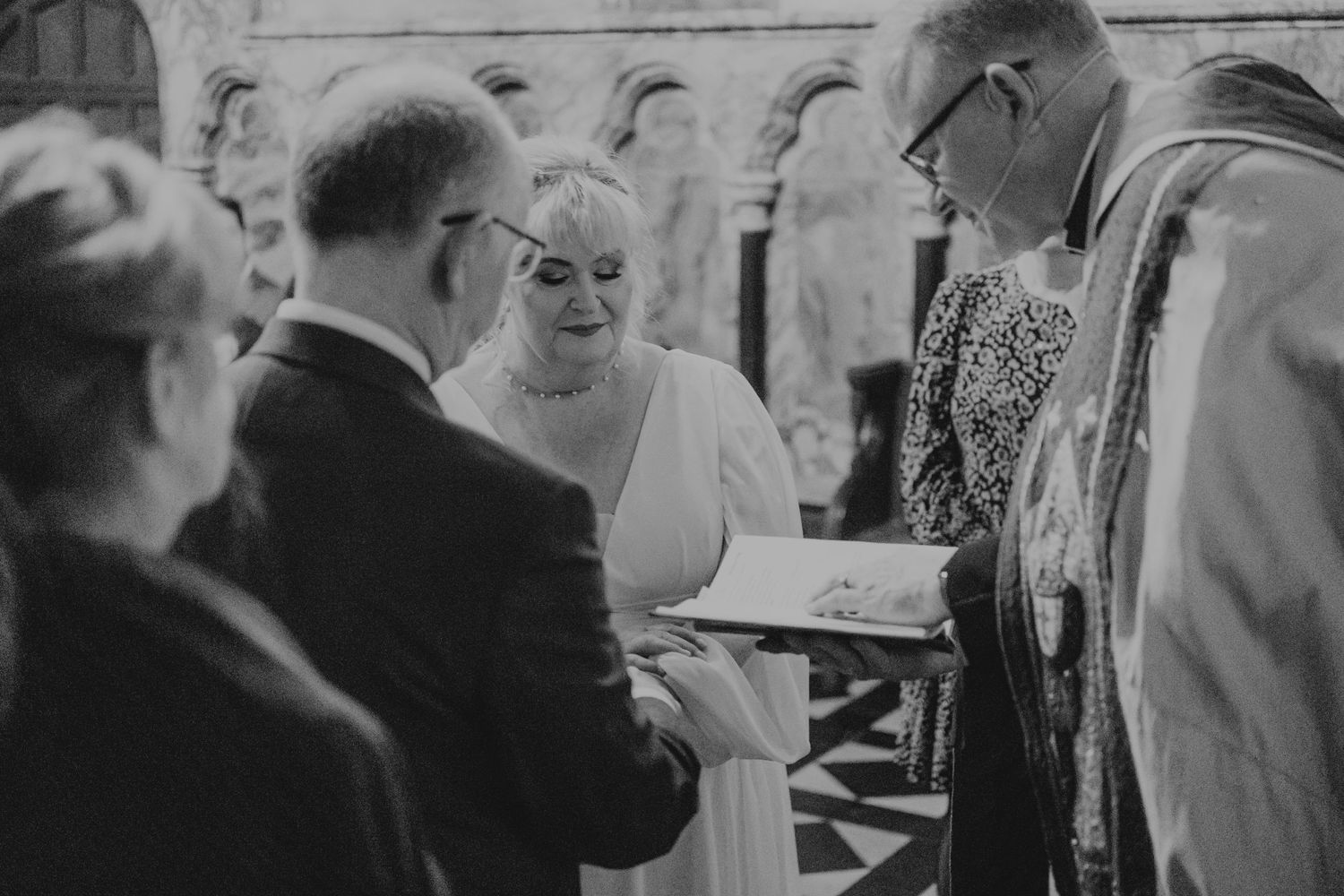 A black and white wedding ceremony moment captured during the exchange of vows.