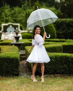 Bridal portrait on rainy day in gorgeous green garden