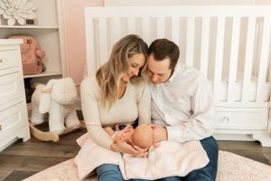 Lifestyle newborn family photo in custom nursery