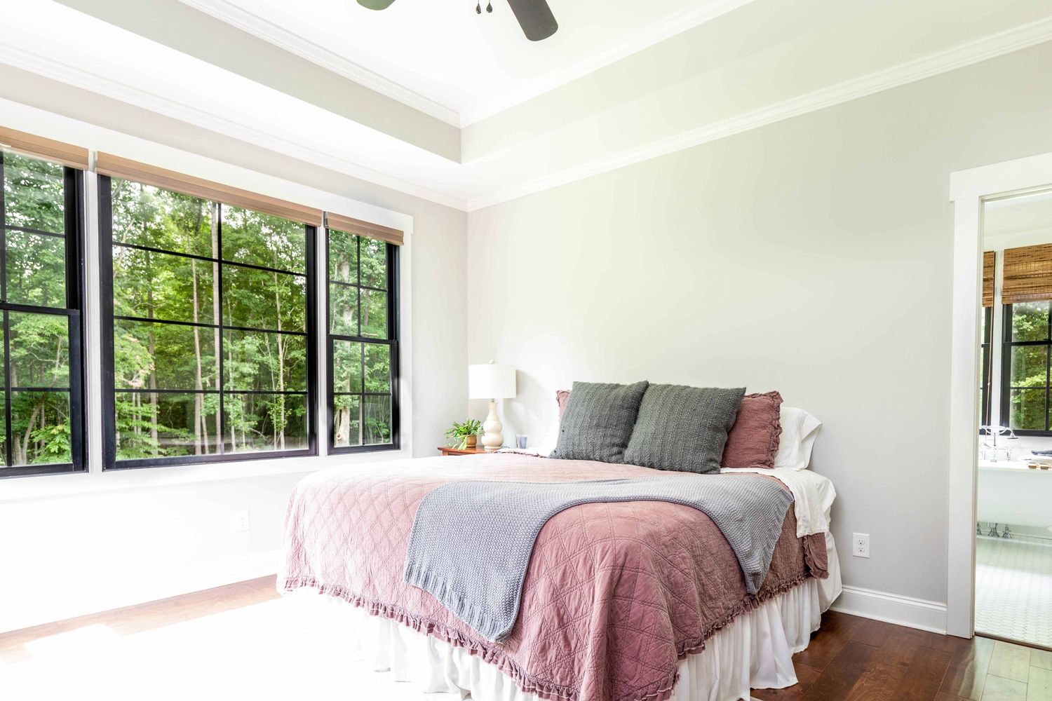 bedroom with view of trees from large windows by victoria leigh photography