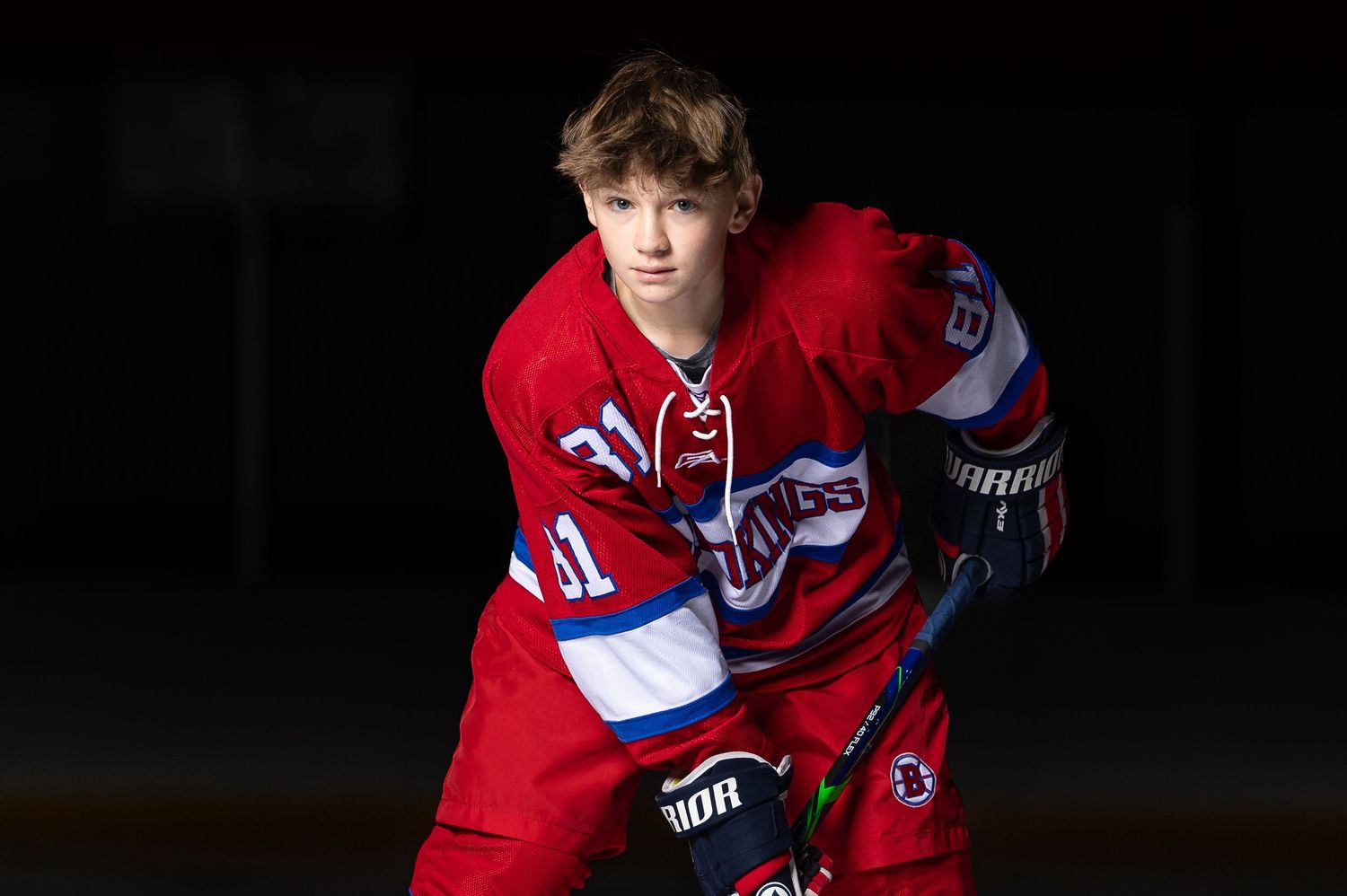 determined hockey player in red with dramatic lighting