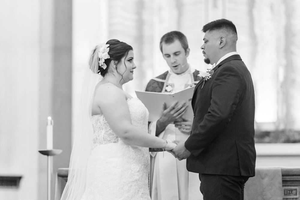 Wedding ceremony in progress with couple and officiant at the altar during vow exchange.