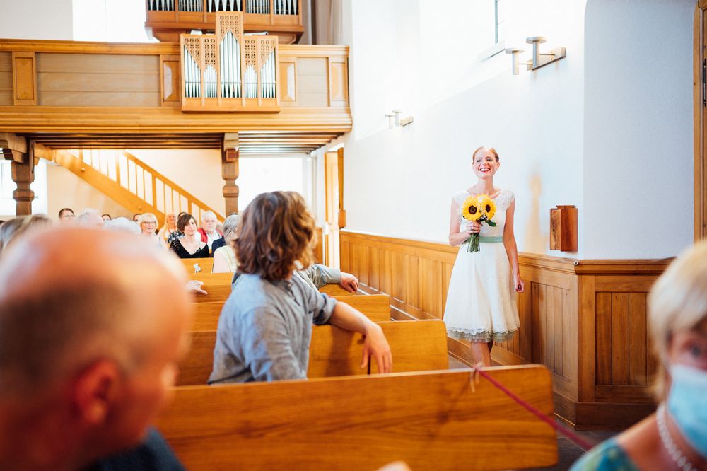 Church interior with wooden pews and organ loft during a celebration.
