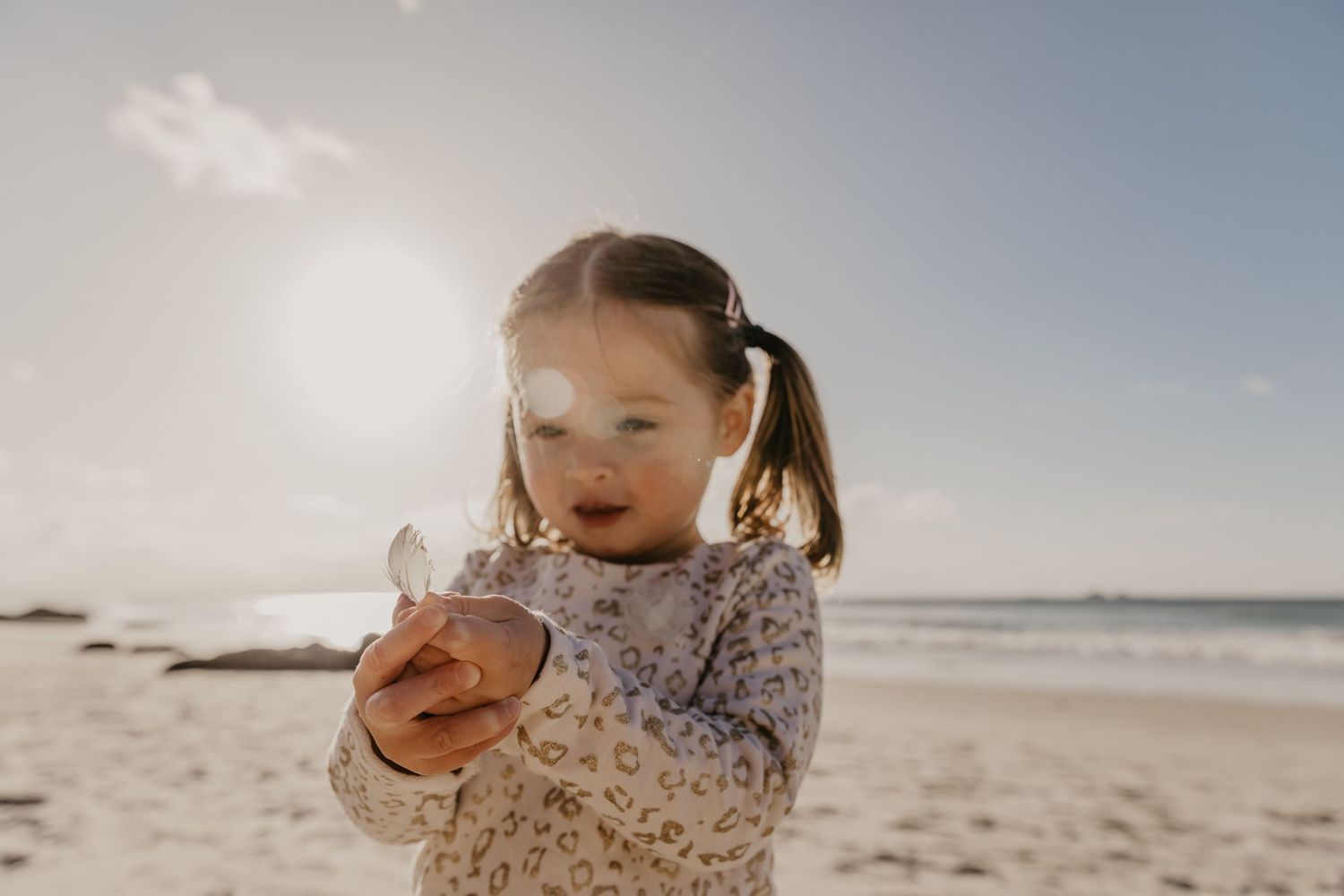 Spring children’s portrait with flowers on the beach in Byron Bay, Australia.