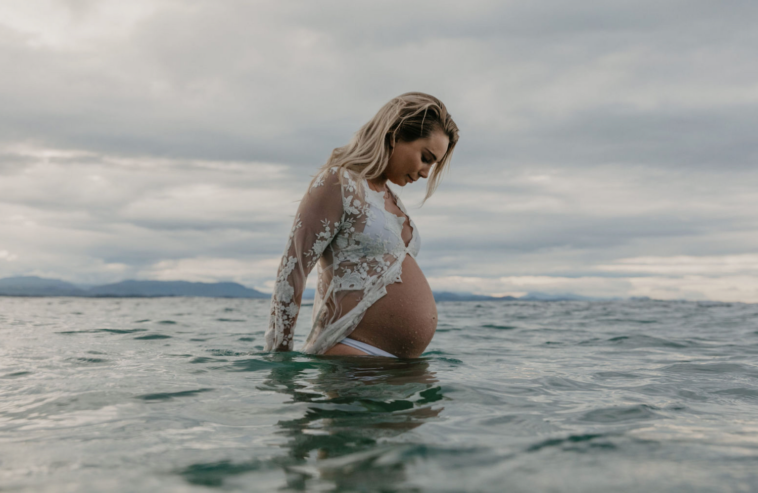 Pregnancy Portrait in the ocean at Byron Bay, NSW, Australia.