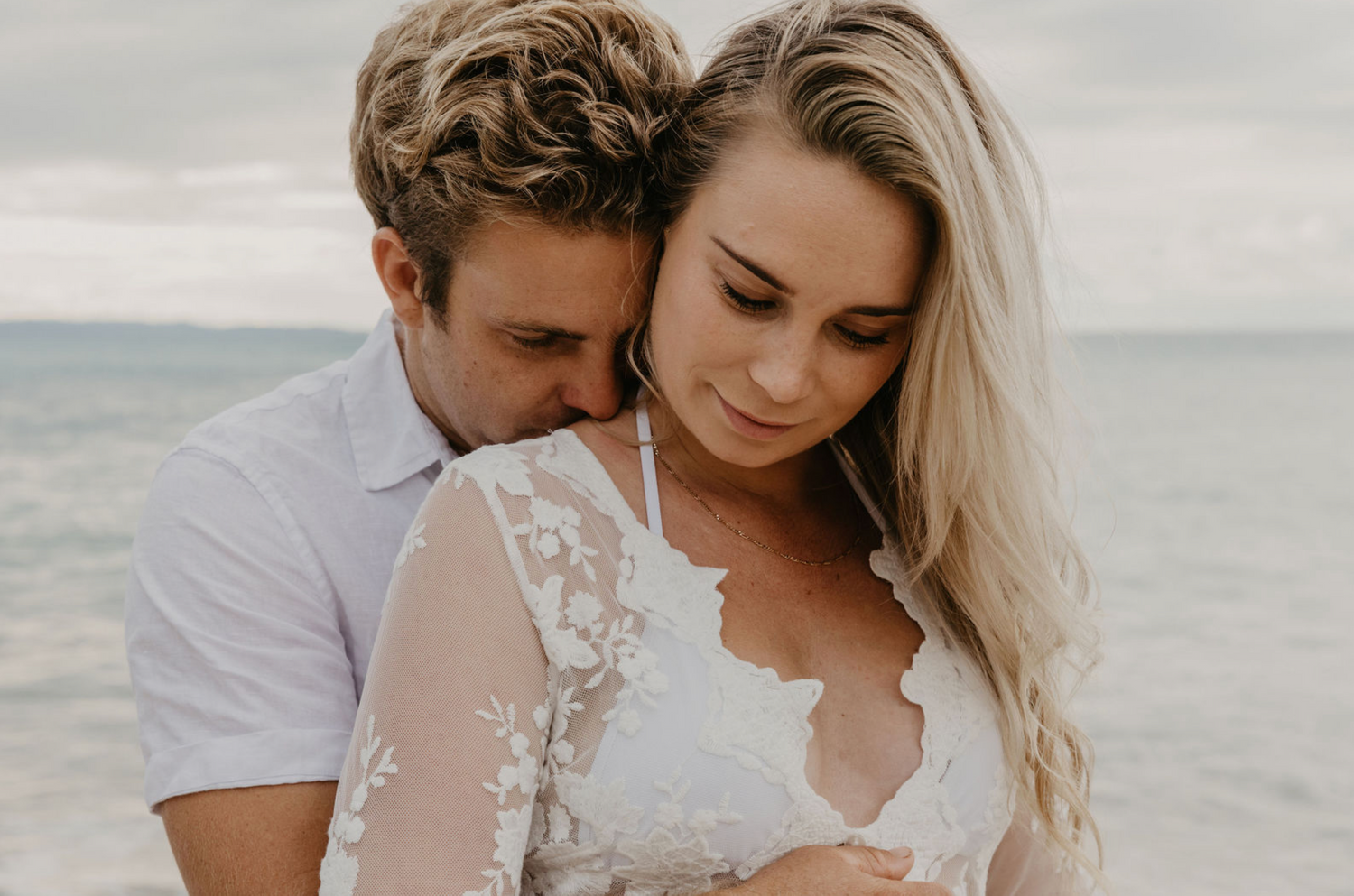 Couple portrait at sunset at beach in Byron Bay, NSW, Australia.