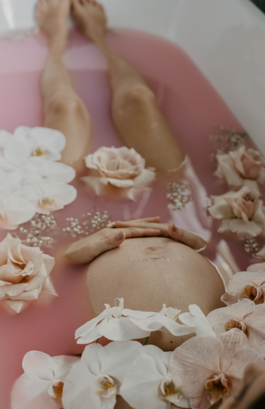 Pregnancy portrait in bath with flowers