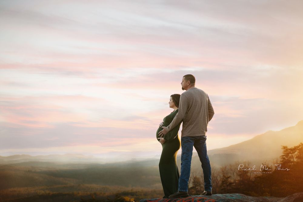 A mom and dad looking out a mountain on bald rock. Greenville, SC newborn photographer, Easley, SC Newborn photographer