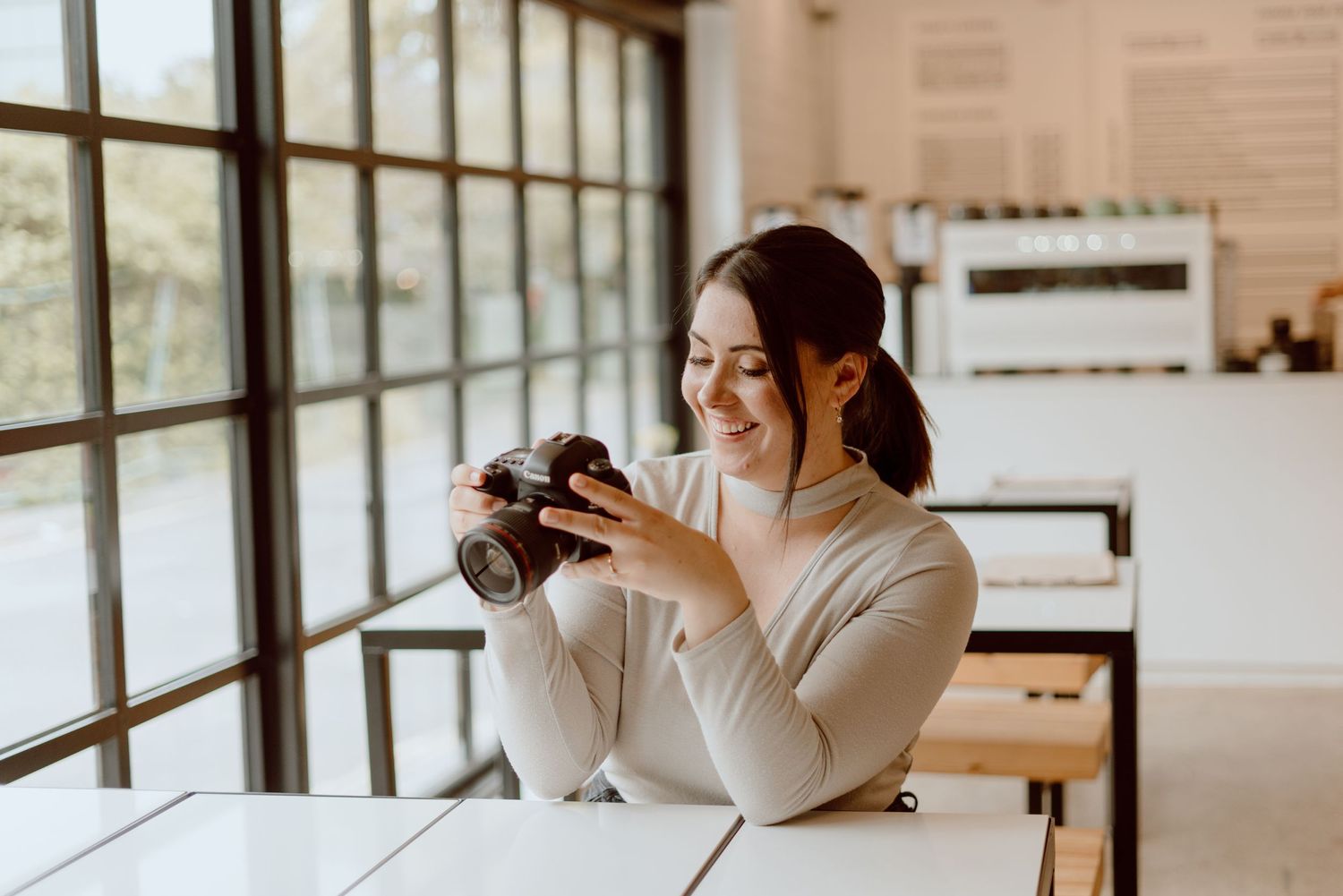 Wedding photographer based in pencoed, bridgend, south wales holding Canon DSLR 5D Mark IV in coffee shop in Bristol