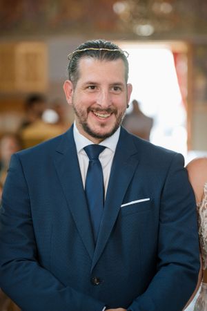 Wedding portrait in navy suit with matching tie and white pocket square.