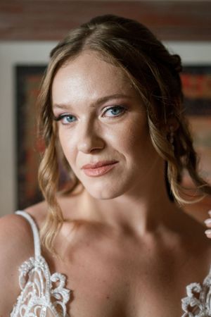 Close-up bridal portrait showcasing natural makeup and elegant hairstyle.