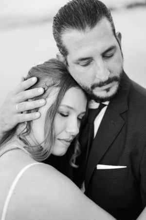 Intimate black and white portrait of couple in formal attire.