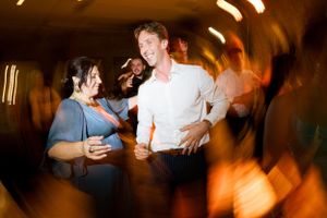 Dynamic party scene with blurred motion and warm lighting at reception.