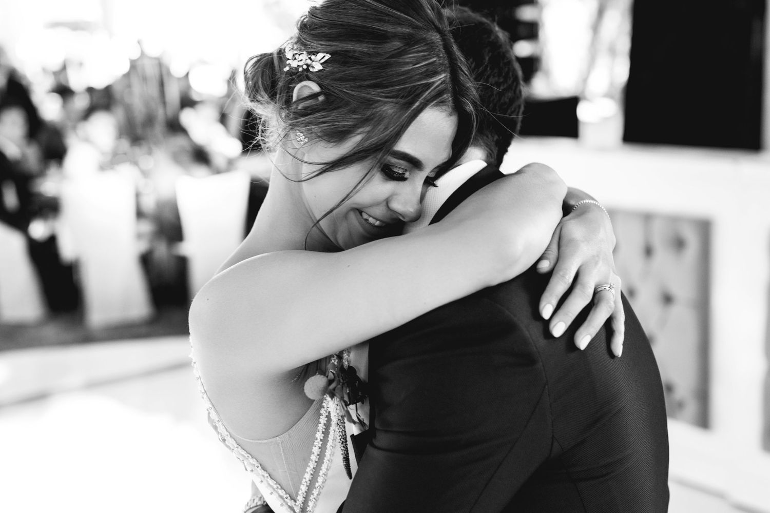 A tender black and white moment captured during an emotional wedding dance.