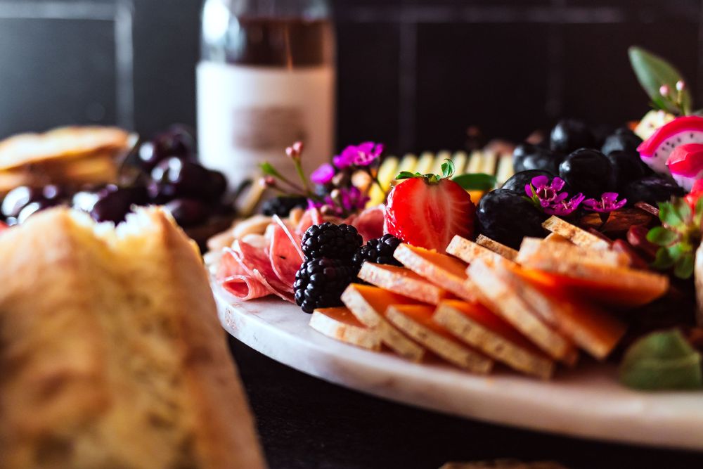 Close up of elegant charcuterie board with cured meats, cheeses and fresh berries for winery and catering branding photography.
