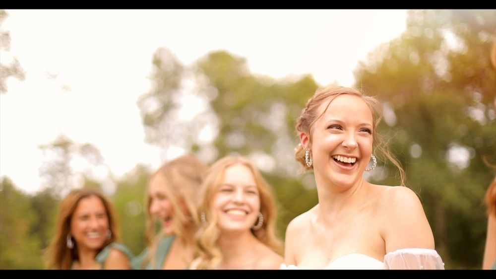 Bride and Bridesmaids Smiling Candid Outdoor Wedding