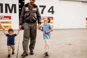 Walking together on a military base near aircraft number 774.