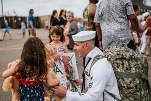 Military homecoming celebration event with families greeting service members.
