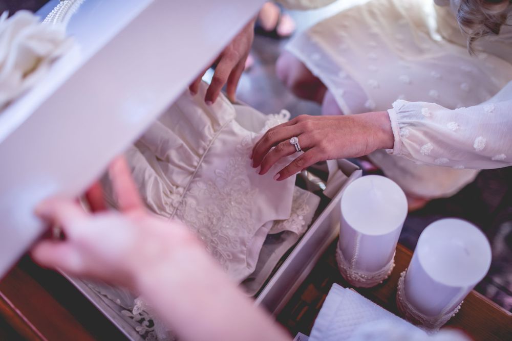 Close-up of hands performing a baptismal ritual with water and white cloth.