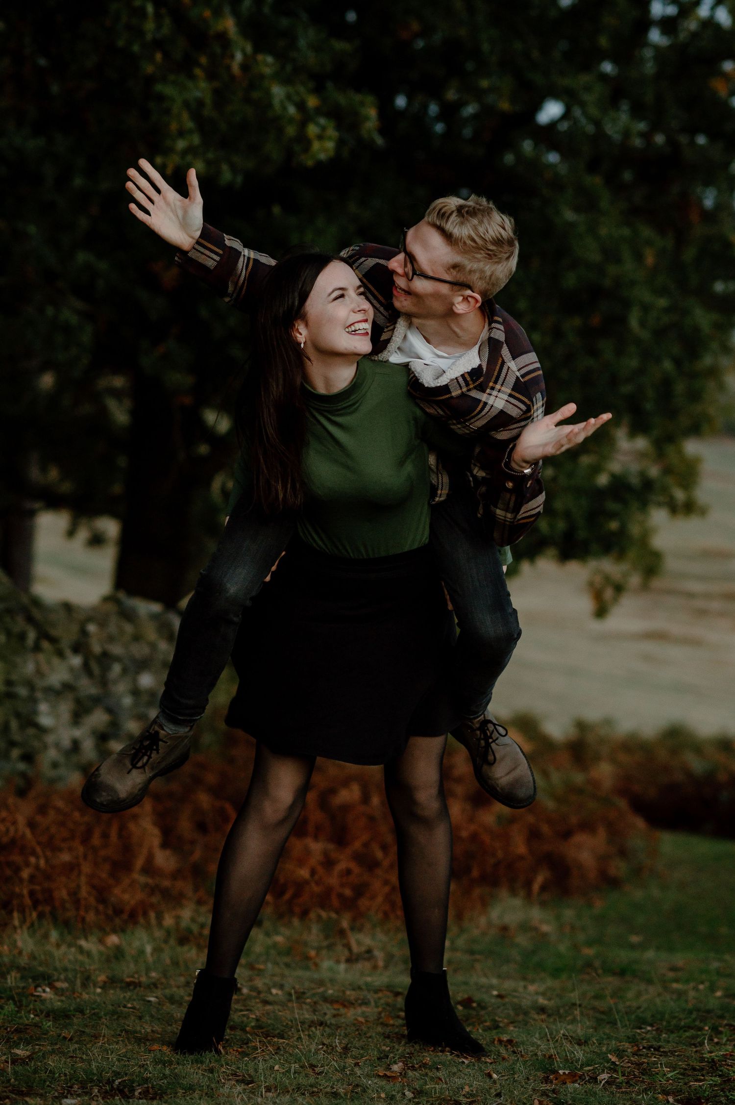 A playful piggyback ride moment captured in an autumn setting.