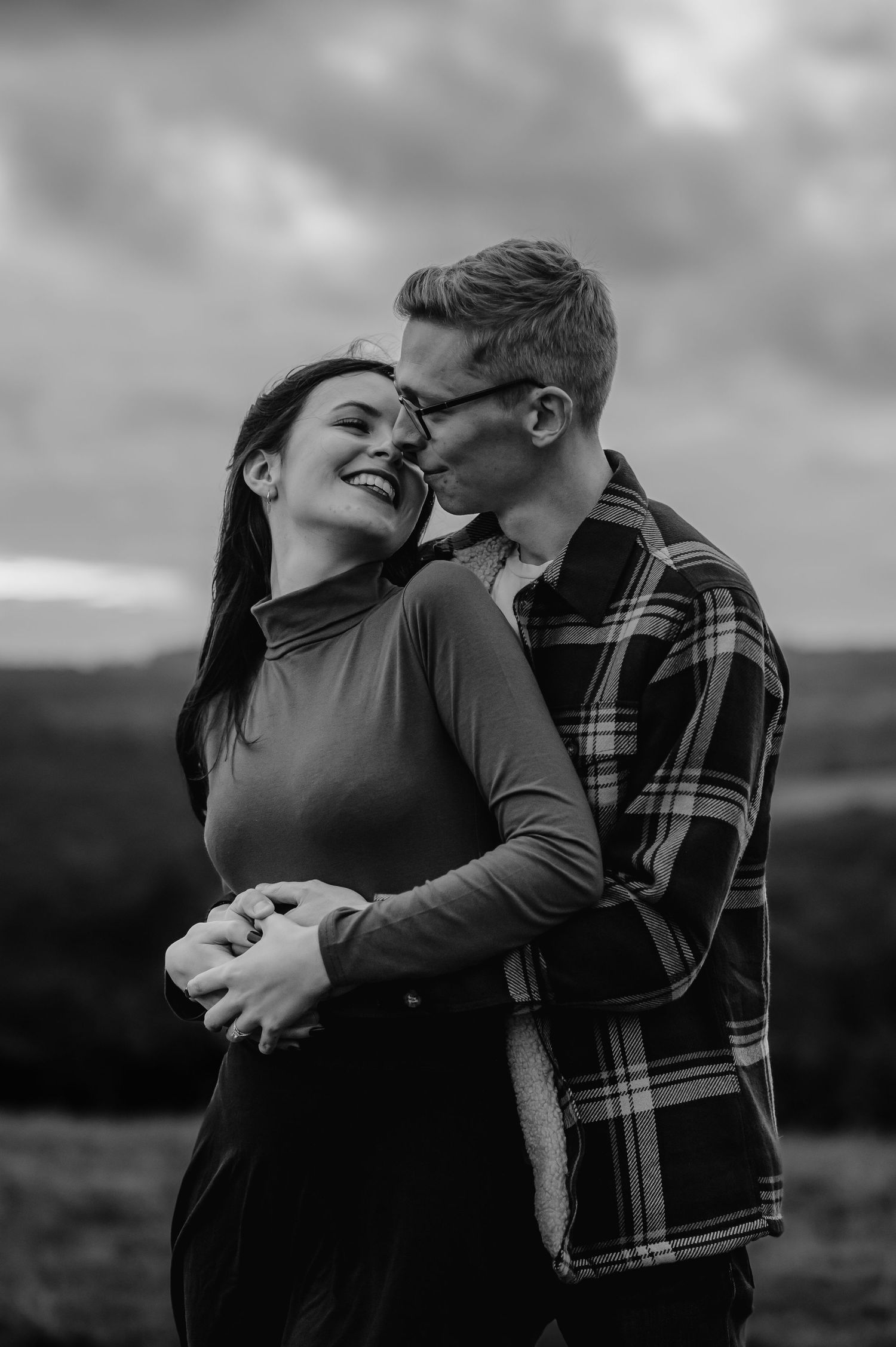 A tender black and white portrait capturing a romantic embrace.