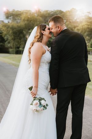 A romantic wedding photoshoot sequence showing tender moments between a couple in formal attire at sunset.