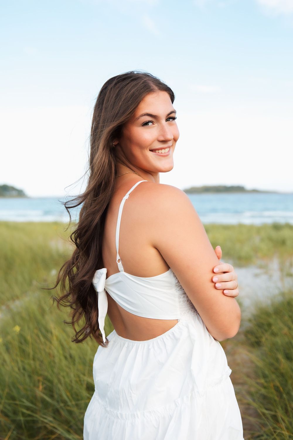 Young woman in white backless dress. senior photo, senior photography. Kennebunkport, ME. Goose Rocks Beach Maine