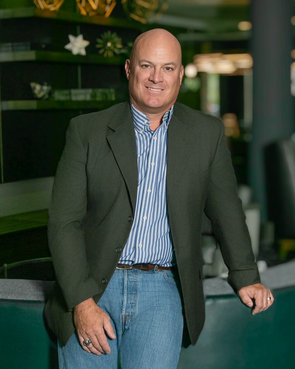 Professional wearing a gray blazer and blue striped shirt in business headshot series.