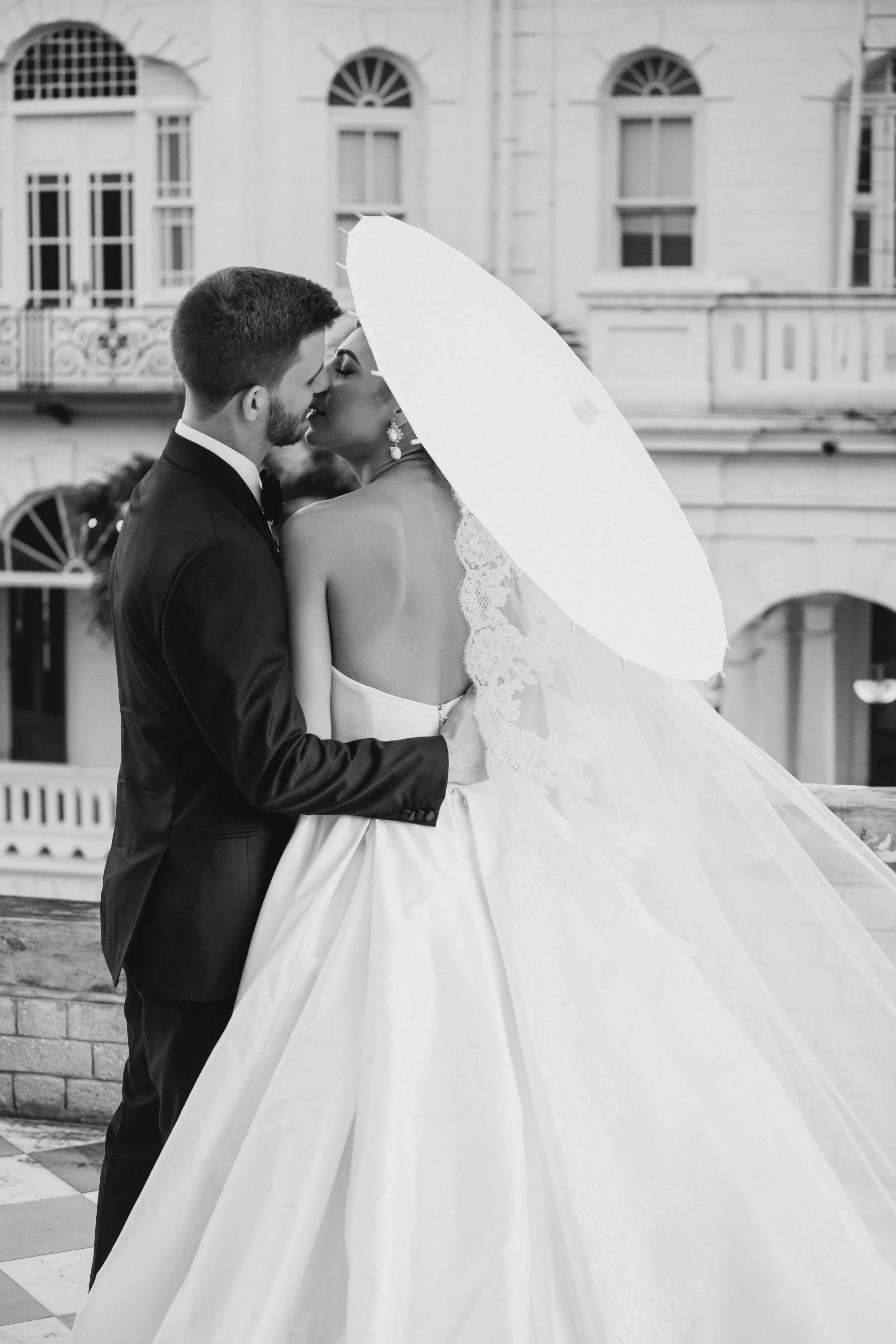 A couple kissing under an umbrella in Trinidad.