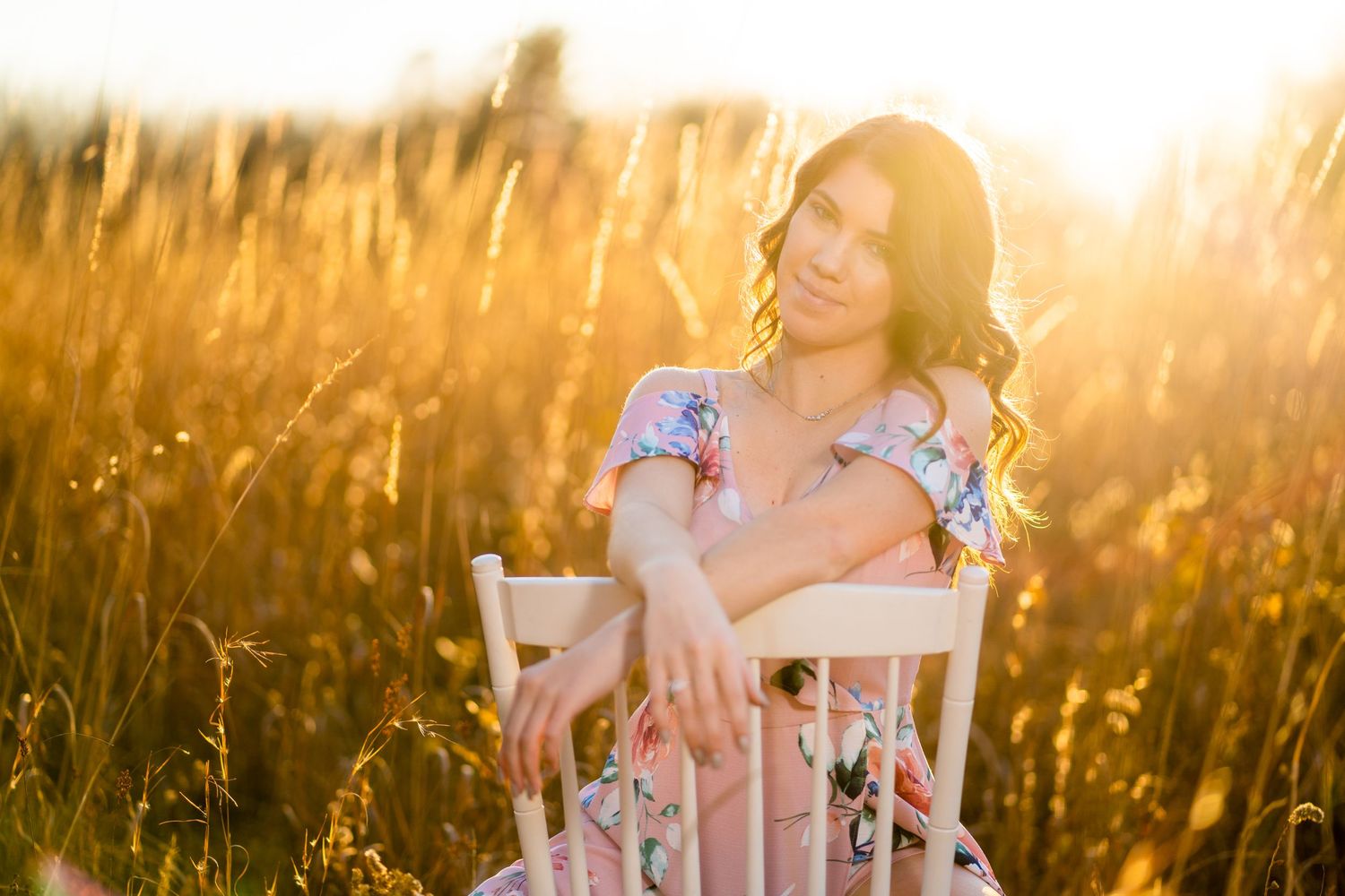 Sunset photography in tall grass with golden backlighting and vintage props.