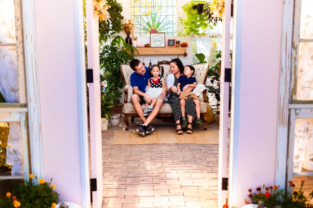 Beautiful San Antonio family having a candid moment in at the picturesque Valerie Marie Greenhouse.