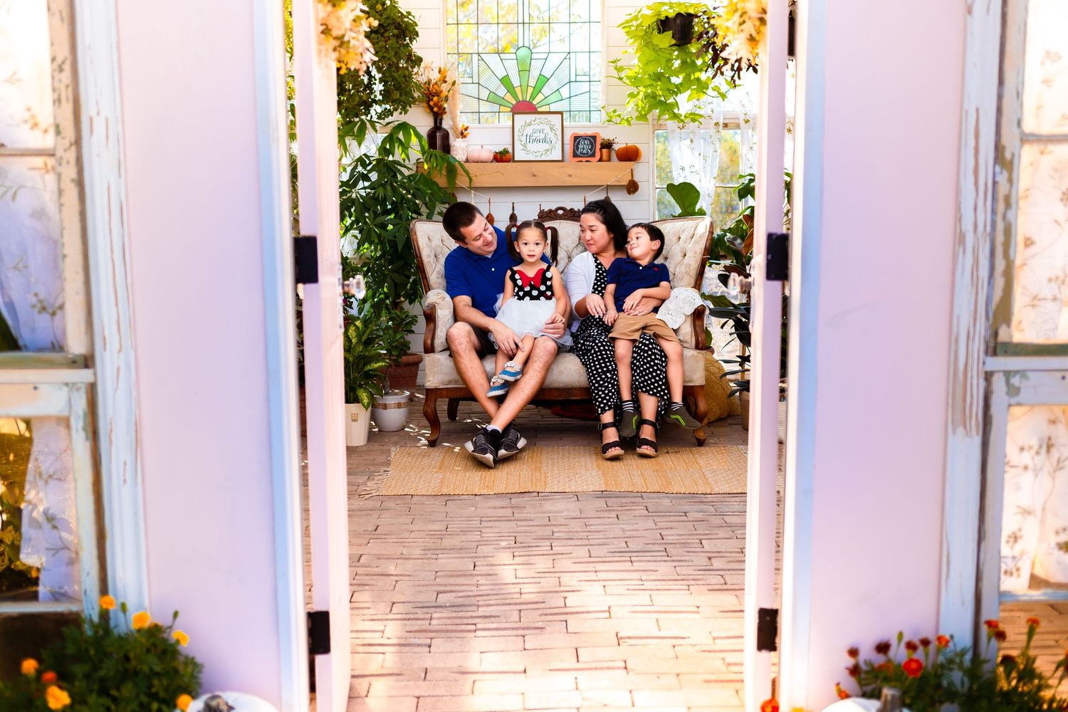 Beautiful San Antonio family having a candid moment in at the picturesque Valerie Marie Greenhouse.