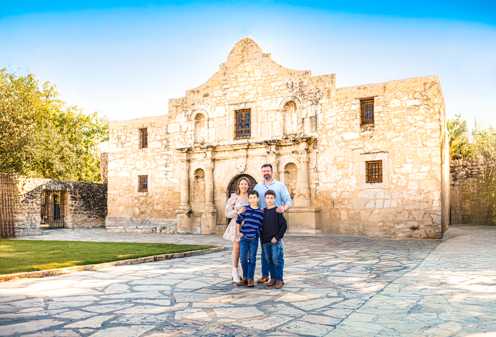 San Antonio family posed in front of the iconic Alamo.