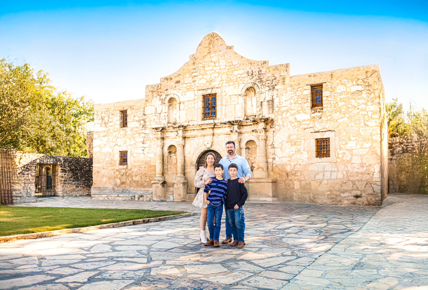 San Antonio family posed in front of the iconic Alamo.