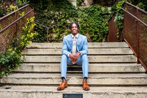 Sharp dressed San Antonio high school senior graduate posing for a portrait at the historical Pearl Brewery.