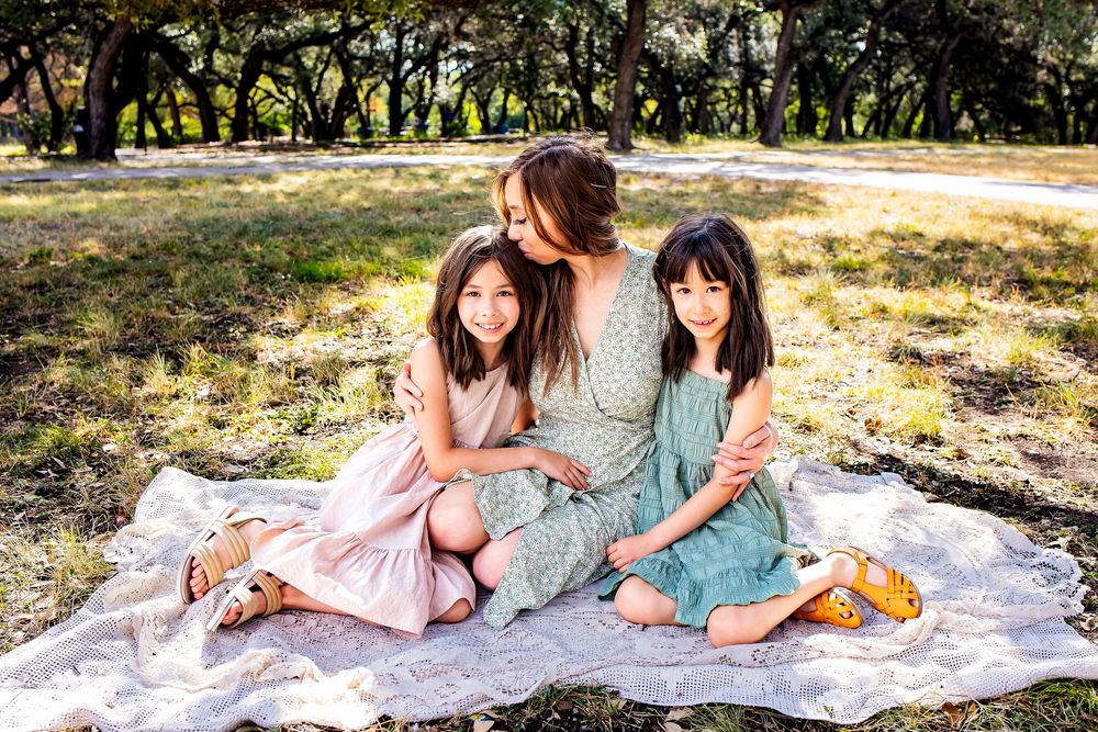 Candid San Antonio family moment in golden sunlight at Denman Estate Park.