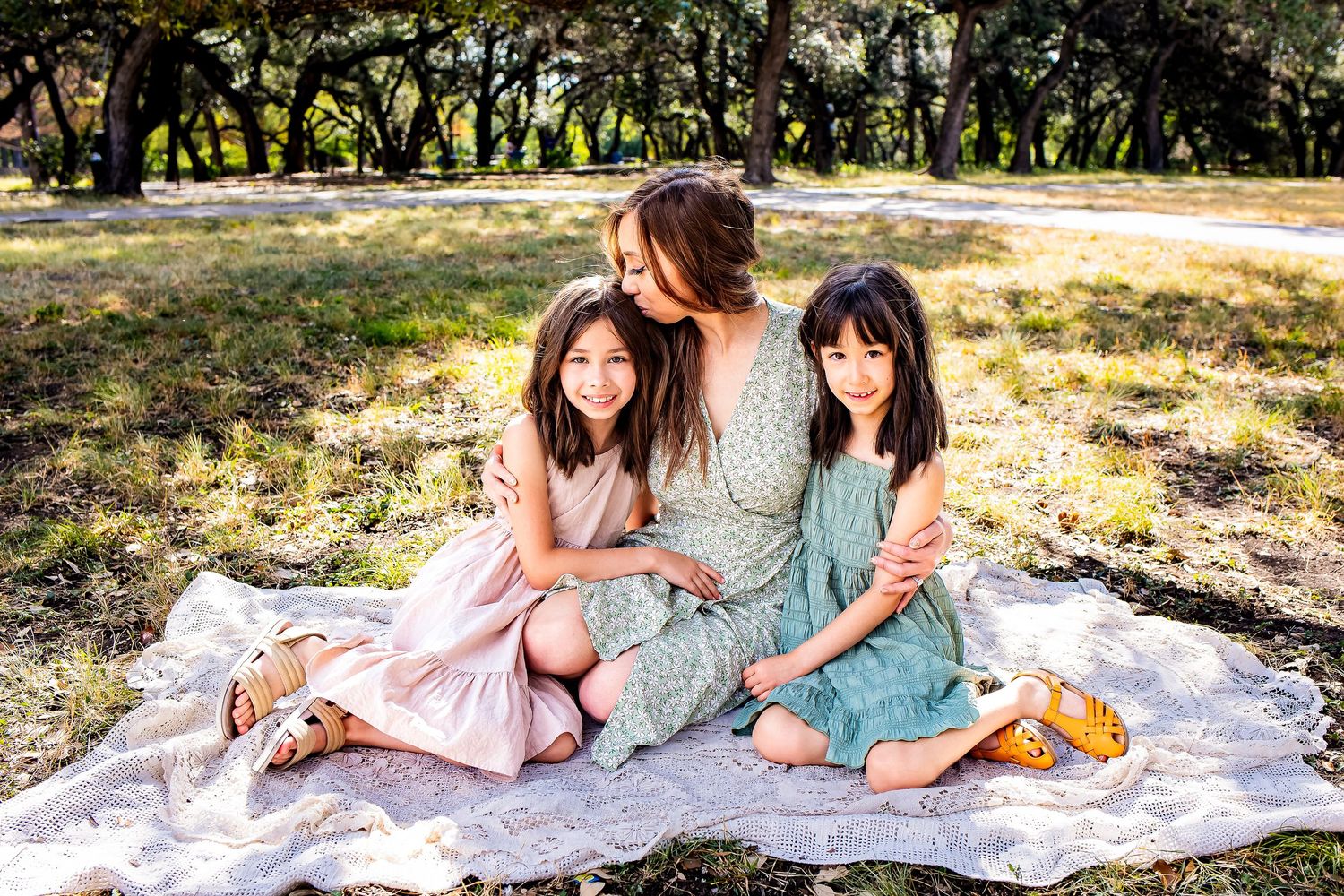 Candid San Antonio family moment in golden sunlight at Denman Estate Park.