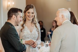 Guests enjoying drinks and conversation at an elegant indoor celebration.