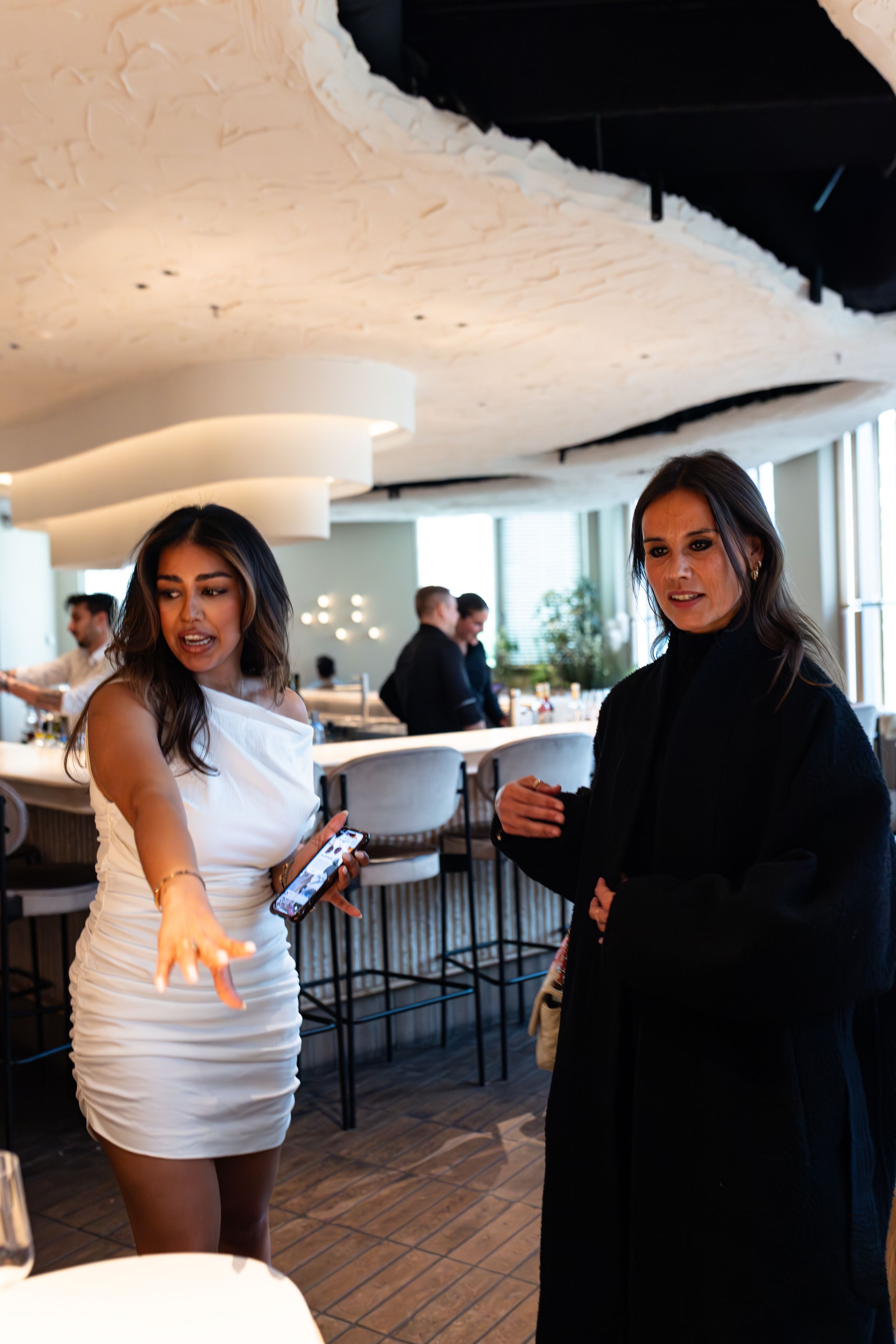Event space with modern decor and guests mingling.