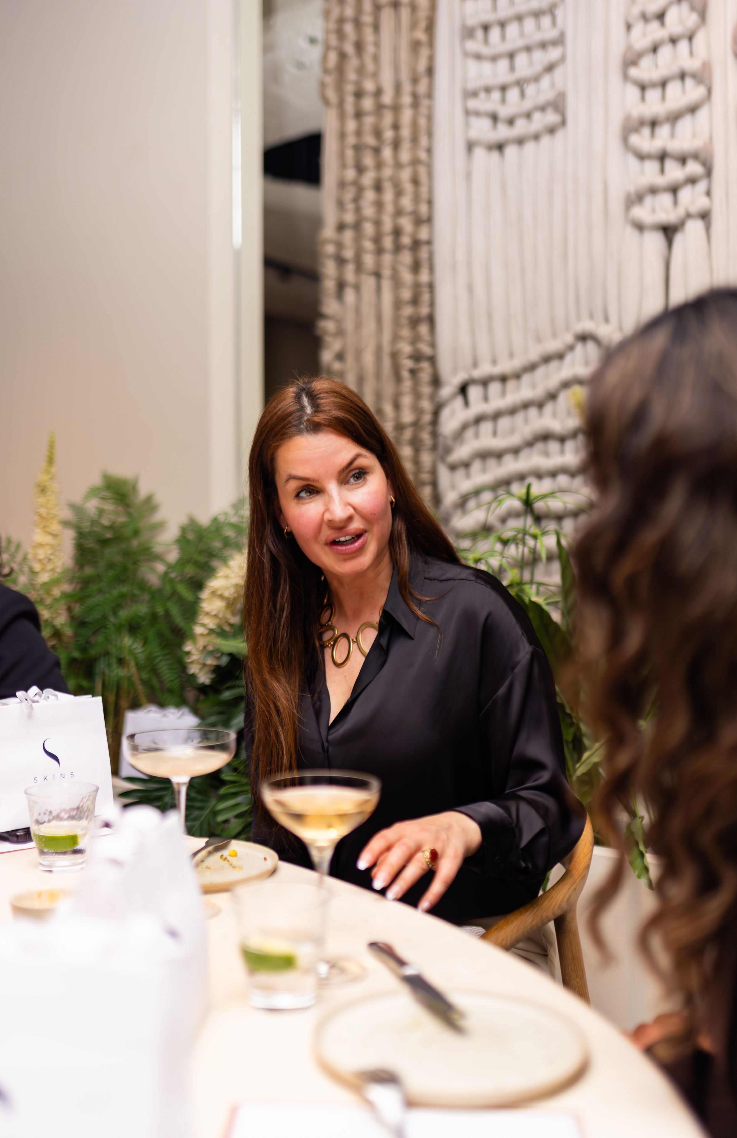 Elegant restaurant interior with modern table settings and decorative wall features.