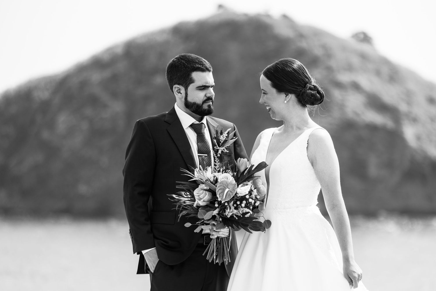 Elegant bride in her wedding dress, walking in hand with her husband,